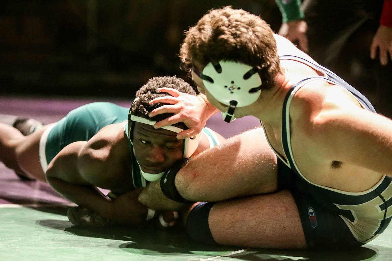 Edmonds-Woodway’s Abdoulie Jatta works to hold Everett’s Jake Leonard in bounds during a 182-pound match Thursday at Edmonds-Woodway High School. (Kevin Clark / The Herald)