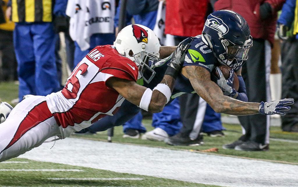 Seahawks wide receiver Paul Richardson dives for extra yardage with Cardinals corner back Brandon Williams defending Saturday afternoon at CenturyLink Field in Seattle on December 24, 2016. The Cardinals won 34-31. (Kevin Clark / The Herald)
