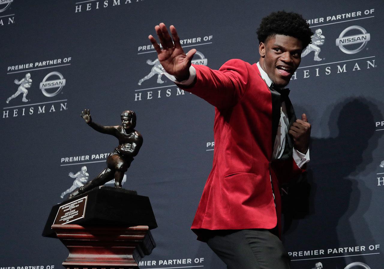Louisville quarterback Lamar Jackson poses after winning the Heisman Trophy on Saturday in New York. Jackson was named the AP College Football Player of the Year on Tuesday. (AP Photo/Julie Jacobson, File)