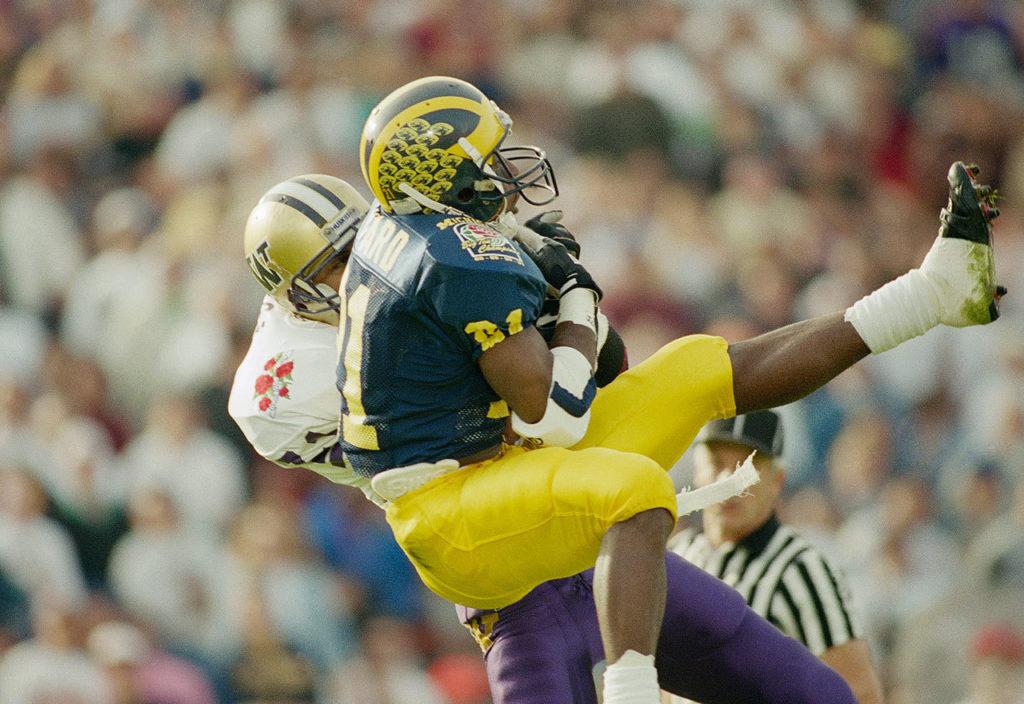 Washington’s Walter Bailey (rear) intercepts a pass intended for Michigan’s Desmond Howard (21) in the first quarter of the Rose Bowl on Jan. 1, 1992, in Pasadena, Calif. Washington won the game 34-14 (AP Photo/Bob Galbraith)
