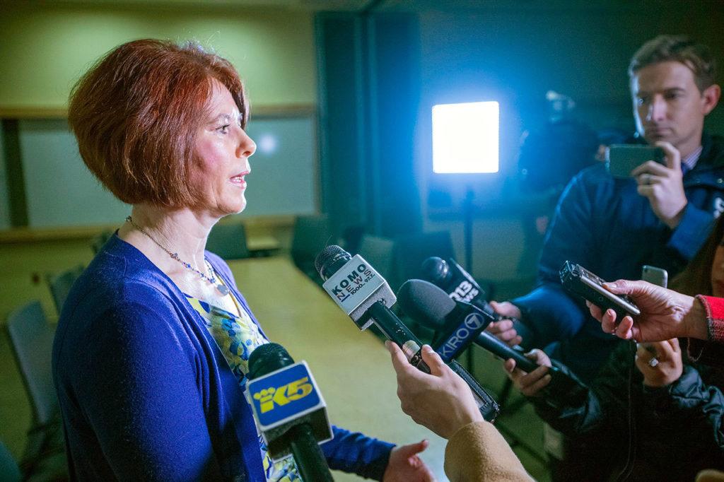 Susan Gregg, spokeswoman for Harborview Medical Center, updates the media on the officer’s condition Friday. (Steve Ringman / The Seattle Times via AP)
