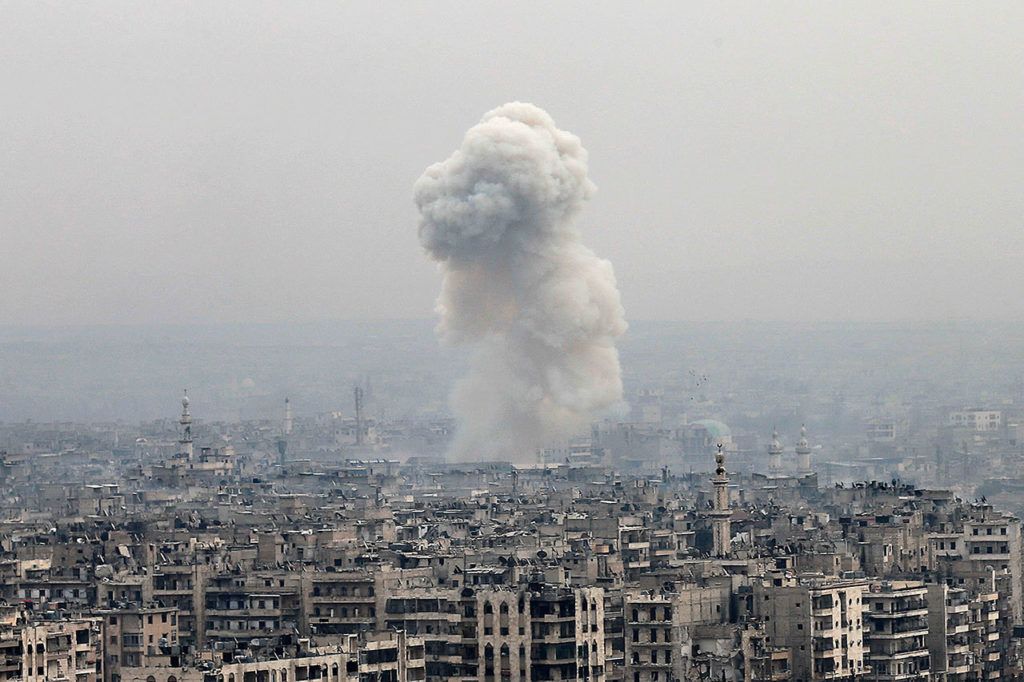 In this Monday, Dec. 5 photo, smoke rises following an air strike hits insurgents positions in eastern neighborhoods of Aleppo, Syria. Aleppo shakes with explosions and gunfire day and night in both the government and rebel sides. (AP Photo/Hassan Ammar, File)
