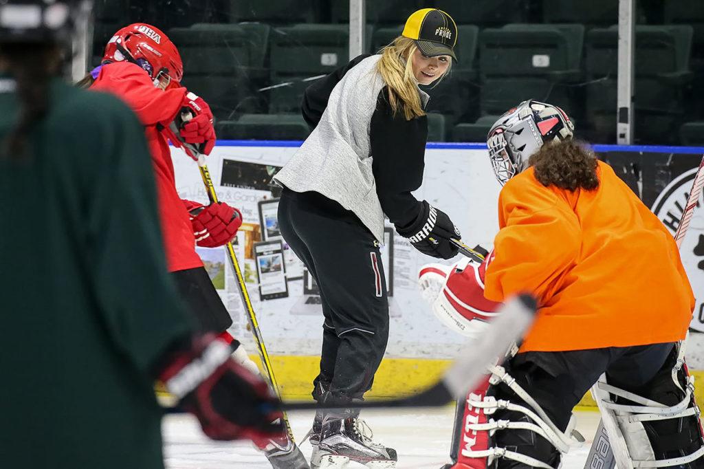 Lexi Bender runs through drills during the women’s hockey clinic she co-hosted Friday afternoon at Xfinity Arena in Everett. (Kevin Clark / The Herald) 
