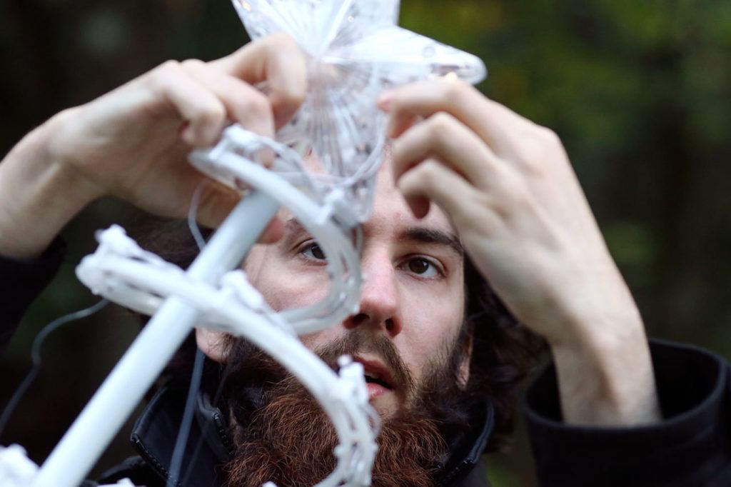 Baily Olson assembles decorations at Warm Beach Lights of Christmas on November 17. (Kevin Clark / The Herald)
