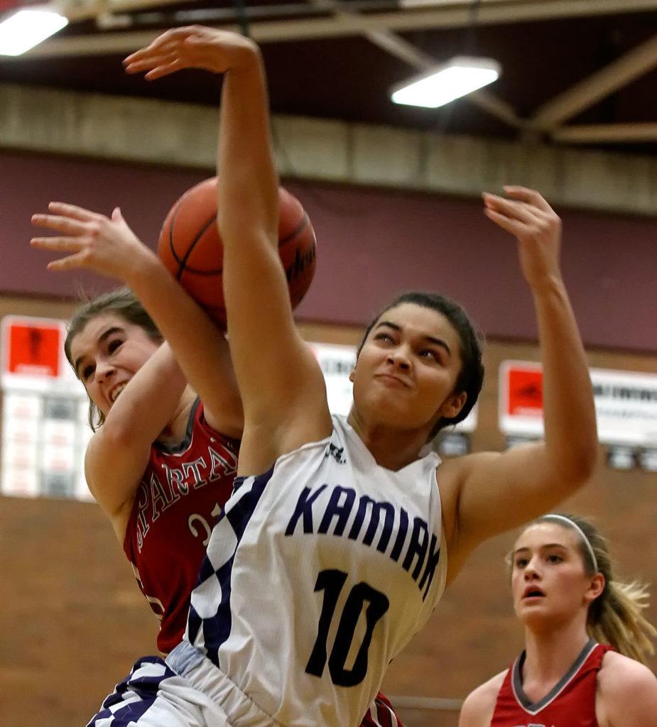 Stanwood’s Madison Chisman (rear) and Kamiak’s Tasia Opstrup vie for the ball during the Mountlake Terrace Holiday Tournament Friday night at Mountlake Terrace High School. (Kevin Clark / The Herald)
