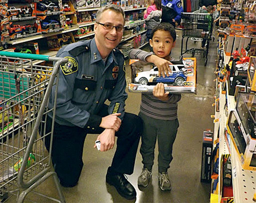 Houston, age 5, selects a toy with Lynnwood Police Chief Tom Davis during this year’s Shop With a Cop event. (Contributed photo)
