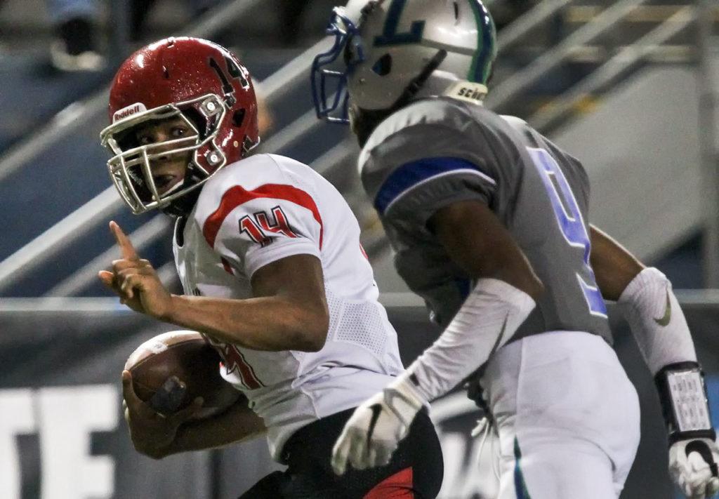 Archbishop Murphy’s Anfernee Gurley looks back to Liberty’s Isaiah Owens after a reception en route to the end zone and touchdown during the 2A state championship game on Saturday at the Tacoma Dome. Archbishop Murphy defeated Liberty 56-14. (Kevin Clark / The Herald)
