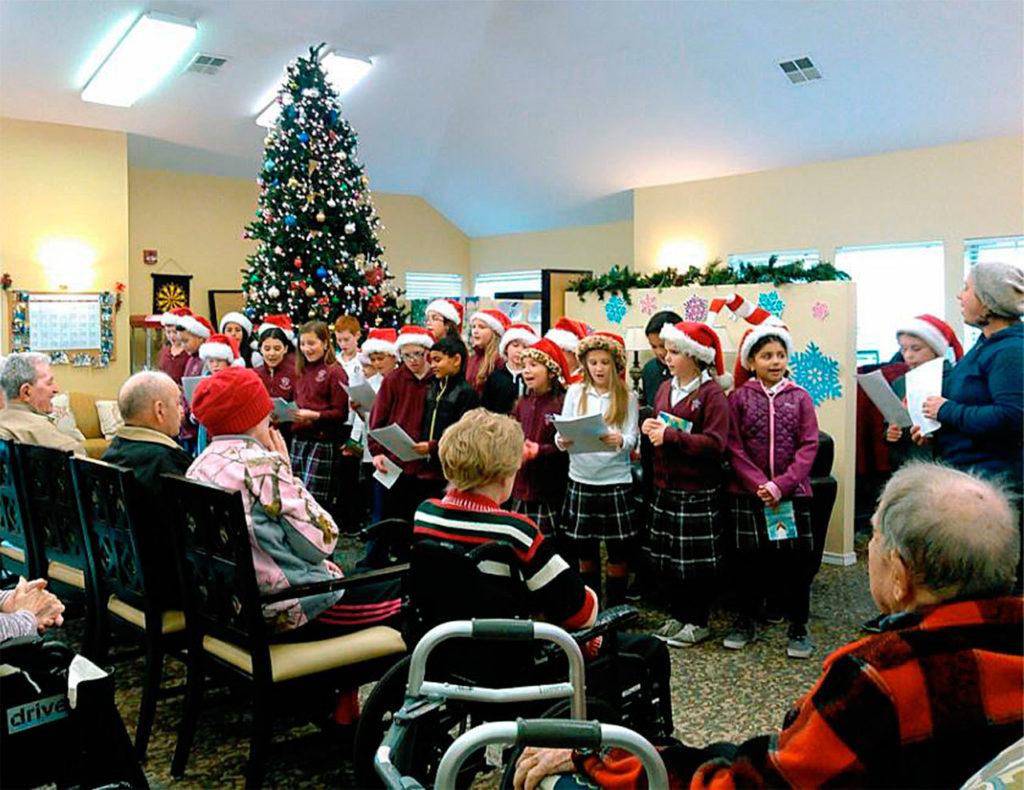 The children of grades 3-5 at St. Michael Catholic School brought some Christmas cheer to residents of Pacifica Senior Living in Snohomish. (Contributed photo)
