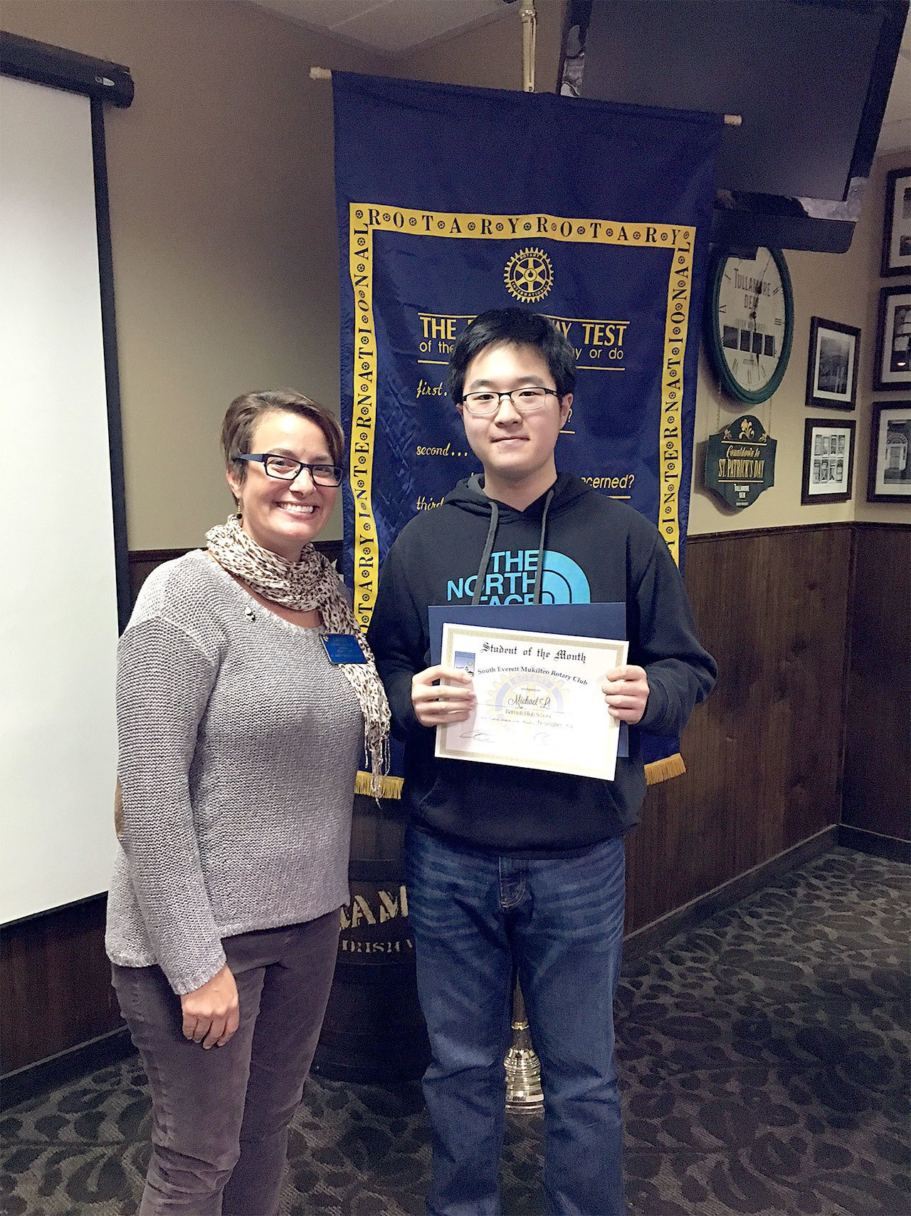 Cassie Franklin, South Everett-Mukilteo Rotary Club president, congratulates Kamiak High School senior Michael Li as one of the club’s Students of the Month for November. (Contributed photo)