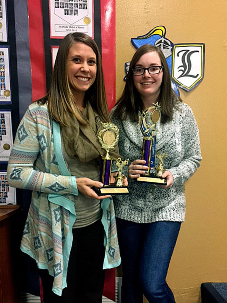 Lowell Elementary School teachers Cristie Smith and Amber McPartland display trophies their school won in an Everett Elks Lodge 479 contest to see which school could donate the most stuffed toys and children’s books for Christmas House. Lowell took first place for books and second place for toys. (Contributed photo)
