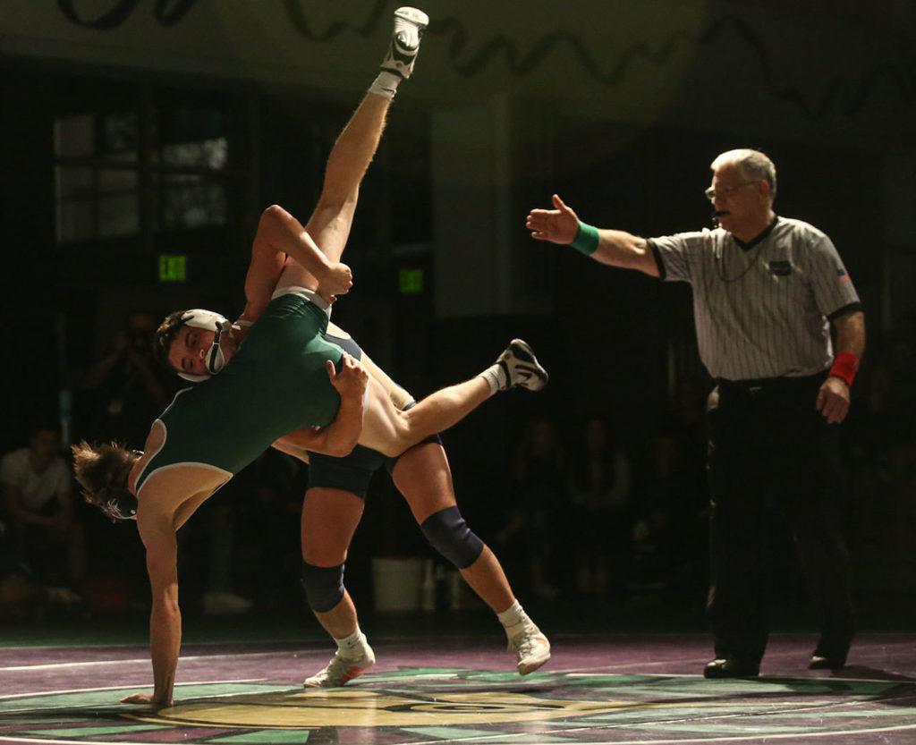 Everett’s Brett Allred takes down Edmonds-Woodway’s Anthony Lindamood during a match Thursday night at Edmonds-Woodway High School. (Kevin Clark / The Herald)
