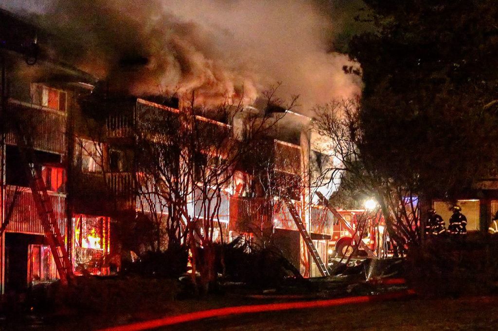 Firefighters battle a three-alarm apartment fire at the Bluffs in Everett on Dec. 31, 2015. (Kevin Clark / Herald file)
