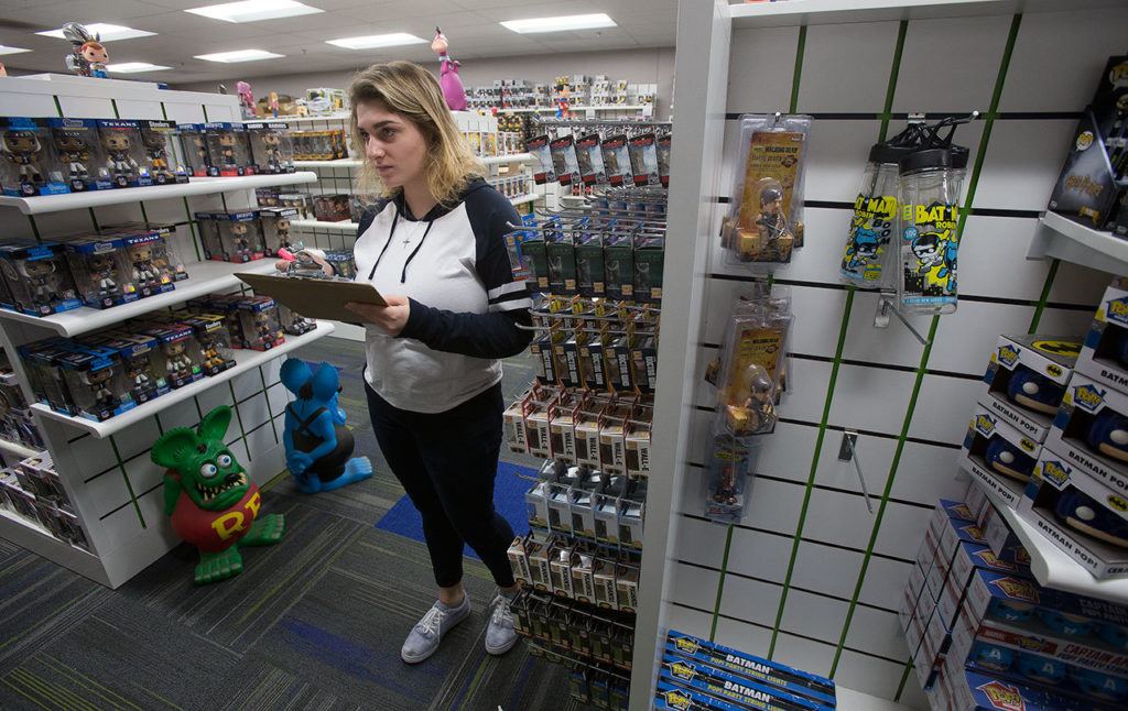 Georgia Paschen takes inventory in the samples room at Funko, a pop culture and licensed-focused collectibles company. (Andy Bronson / The Herald)
