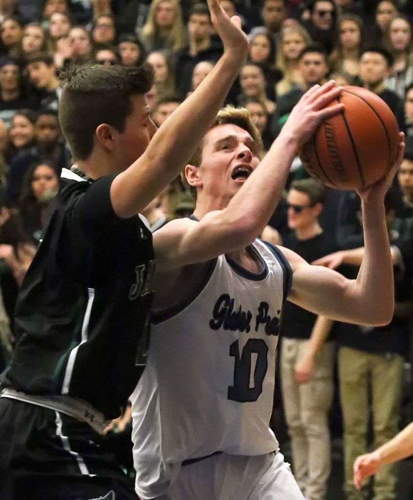 Jackson’s Jordan Brajcich (left) defends a shot attempt by Glacier Peak’s Seiver Southard during a game Friday at Glacier Peak High School in Snohomish. The Grizzles defeated the Timberwolves 64-41. (Kevin Clark / The Herald)
