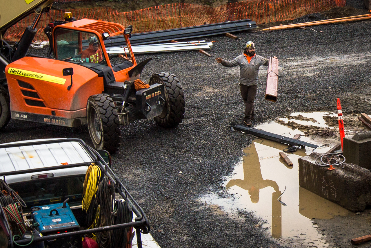 Construction workers transport building materials onsite at the new Park Place Middle School on Monday in Monroe. The project is in Phase One with reconstruction of classrooms, fields, gymnasium and a cafeteria set to be completed by 2018. (Daniella Beccaria / The Herald)

