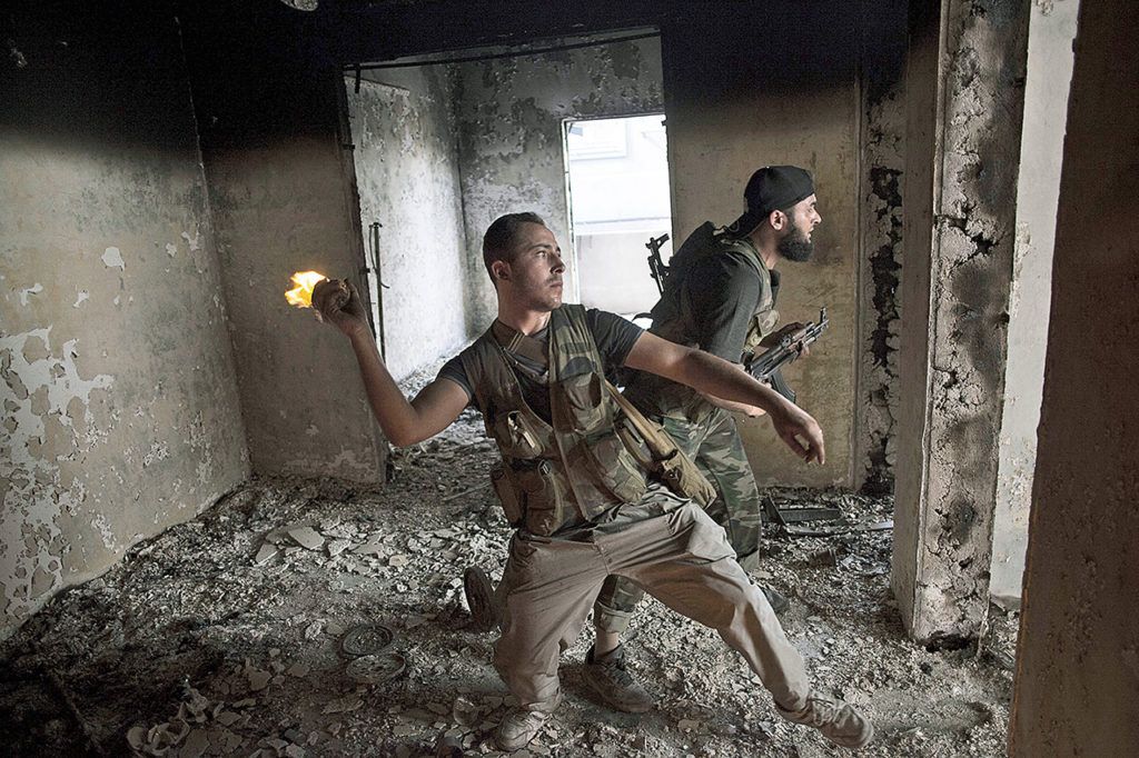 Free Syrian Army soldiers throws a petrol bomb against Syrian Army positions in Saif Al Dawle district in Aleppo, Syria, on Oct. 3, 2012. (AP Photo /Manu Brabo, File)
