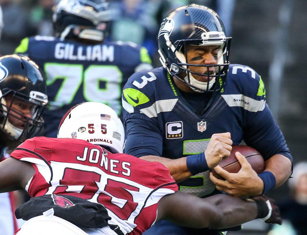 Seahawks quarterback Russell Wilson is sacked by Cardinals linebacker Chandler Jones Saturday afternoon at CenturyLink Field in Seattle on December 24, 2016. The Cardinals won 34-31. (Kevin Clark / The Herald)
