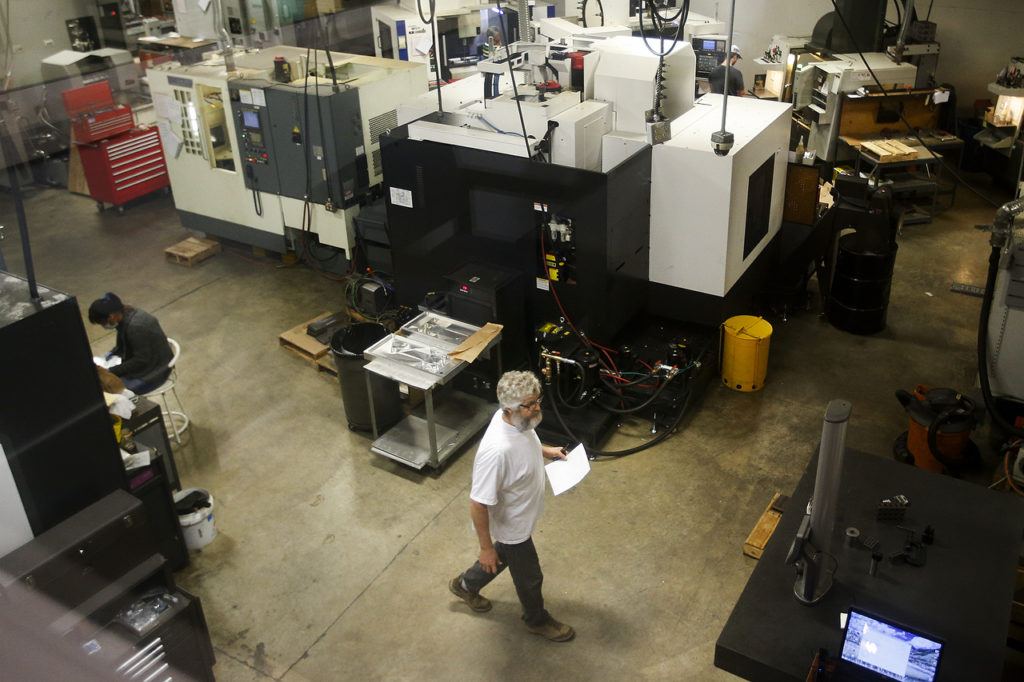 A worker walks along the shop floor of RB Enterprises in Mukilteo on Wednesday. (Ian Terry / The Herald)

