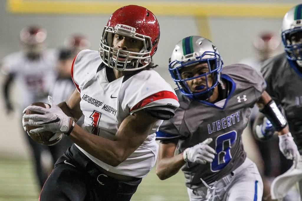 Archbishop Murphy’s Kyler Gordon races for the end zone and a touchdown with Liberty’s Dulin Hayden trailing during the 2A state championship game on Saturday at the Tacoma Dome. Archbishop Murphy defeated Liberty 56-14. (Kevin Clark / The Herald)
