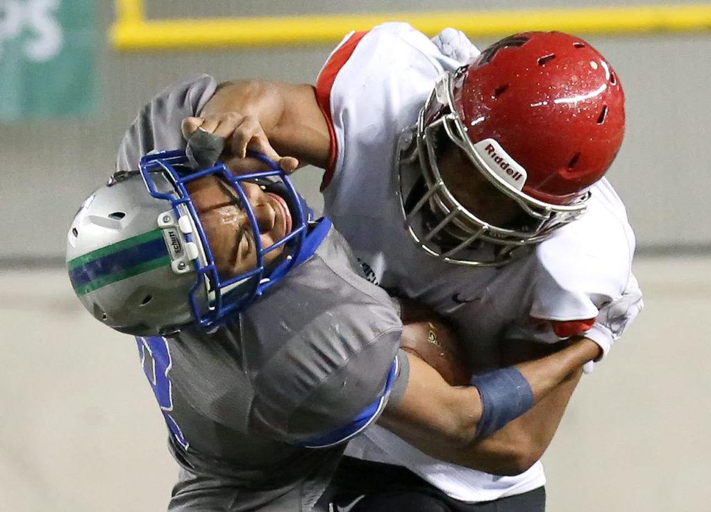 Archbishop Murphy’s Anfernee Gurley stiff-arms Liberty’s Dulin Hayden during the 2A state championship game on Saturday at the Tacoma Dome. Archbishop Murphy defeated Liberty 56-14. (Kevin Clark / The Herald)
