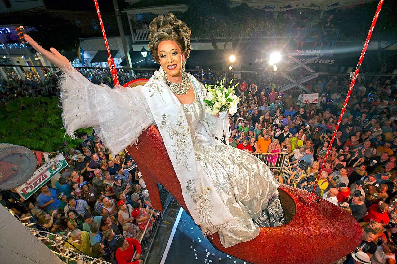 Female impersonator Gary Marion, known as Sushi, hangs in a giant replica of a woman’s high heel shoe in Key West, Florida, on Dec. 31, 2015. (Rob O’Neal / Florida Keys News Bureau)