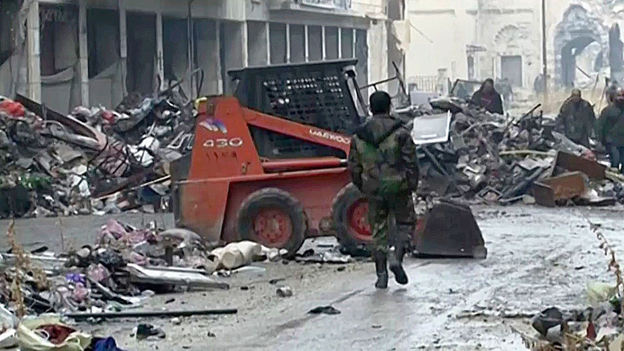 This frame grab from a Dec. 13 video shows Syrian soldiers walking among damaged buildings on a street filled with debris near the ancient Umayyad Mosque, in the Old City of Aleppo, Syria. A cease-fire deal between rebels and the Syrian government in the city of Aleppo has effectively collapsed, Wednesday, Dec. 14, with fighter jets resuming their devastating air raids over the opposition’s densely crowded enclave in the east of the city. (AP Photo)