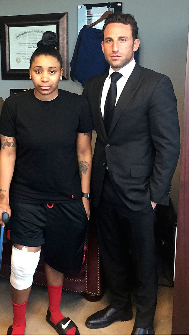 In this April 2016 photo, Marc Eli Freund stands next to his client Katrina Williams at the law firm’s offices in New York, as she recovers from injuries she said says she got from an exploding e-cigarette. The rising popularity of e-cigarettes has been accompanied by a climbing number of incidents of explosions in the decade since their debut. (Lipsig, Shapey, Manus & Moverman P.C. via AP)
