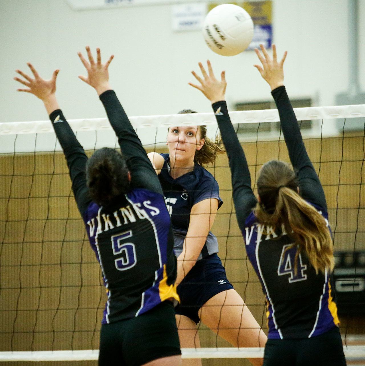 Glacier Peak’s Lauren Sanders (center) spikes the ball through the outstretched arms of Lake Stevens’ Gabby Gunterman (left) and Grace Schroedl (right) during a game at Lake Stevens High School on Oct. 18. Sanders and Gunterman were both named to The Herald’s 2016 All-Area Volleyball Team. (Ian Terry / The Herald)