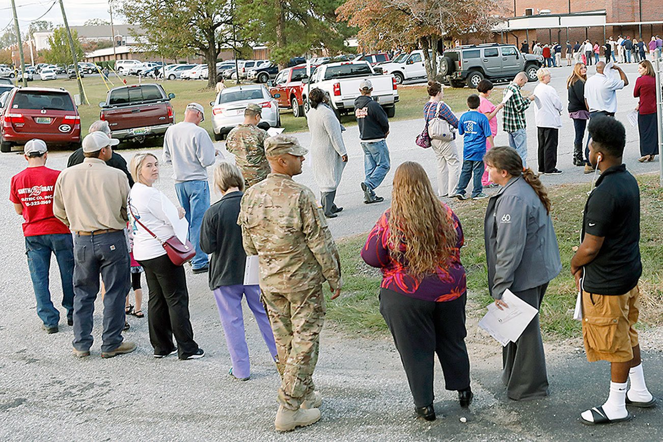 People stand in a long line to vote at the Smiths Station Jr High polling place in Smiths Station, Ala., on Tuesday, Nov. 8, 2016.(Todd J. Van Emst/Opelika-Auburn News via AP)