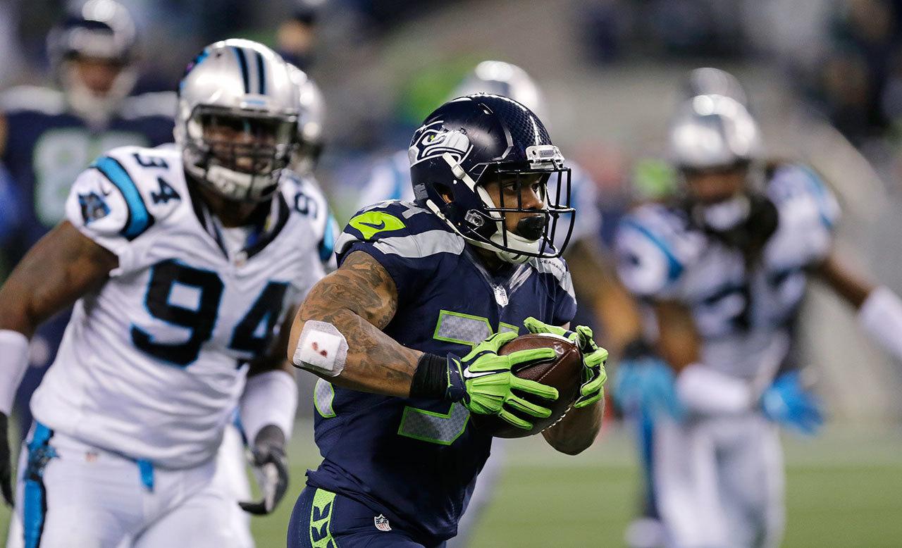 Seahawks’ Thomas Rawls breaks free on a touchdown run against the Panthers in a game on Sunday in Seattle. (AP Photo/Stephen Brashear)