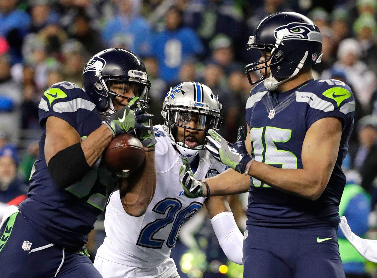 Seahawks wide receiver Doug Baldwin makes a catch for a touchdown as Lions strong safety Don Carey and Seahawks wide receiver Jermaine Kearse look on in the second half of Saturday’s game. (AP Photo/Elaine Thompson)