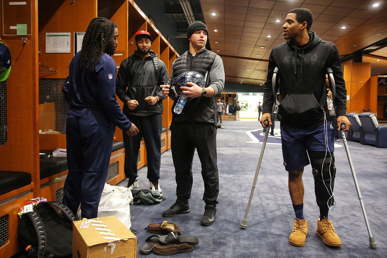 From left, Seahawks running back Alex Collins, linebacker K.J. Wright, linebacker Brock Coyle and cornerback DeShawn Shead chat Sunday at the Virginia Mason Athletic Center in Renton. (Genna Martin/seattlepi.com via AP)