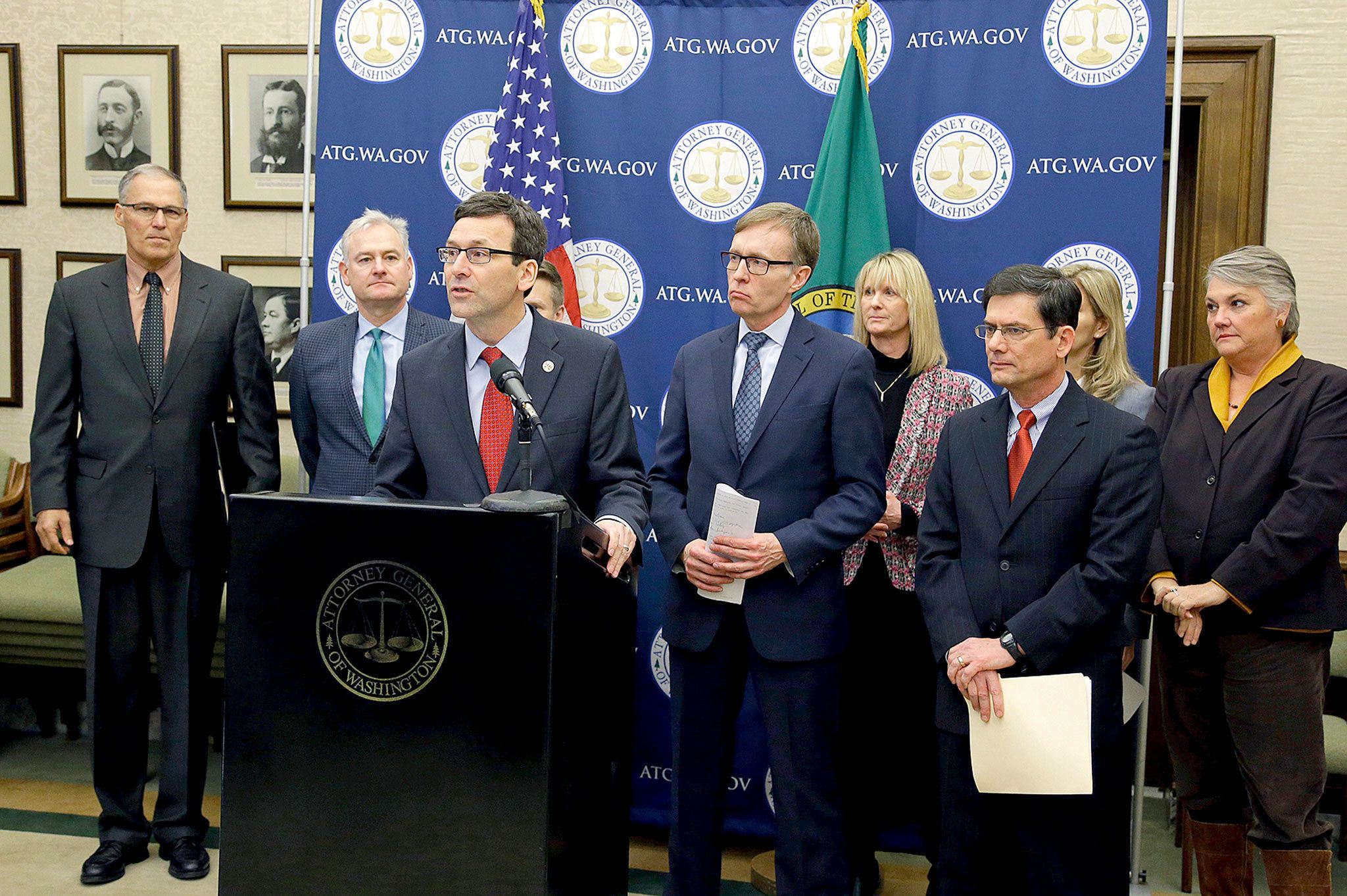 State Attorney General Bob Ferguson (third from left) is flanked by supporters, including Washington Gov. Jay Inslee (left) and former Attorney General Rob McKenna (fourth from left) as he speaks Monday during a news conference at the Capitol in Olympia to announce that he and Inslee have proposed legislation to abolish the death penalty in Washington. (AP Photo/Ted S. Warren)