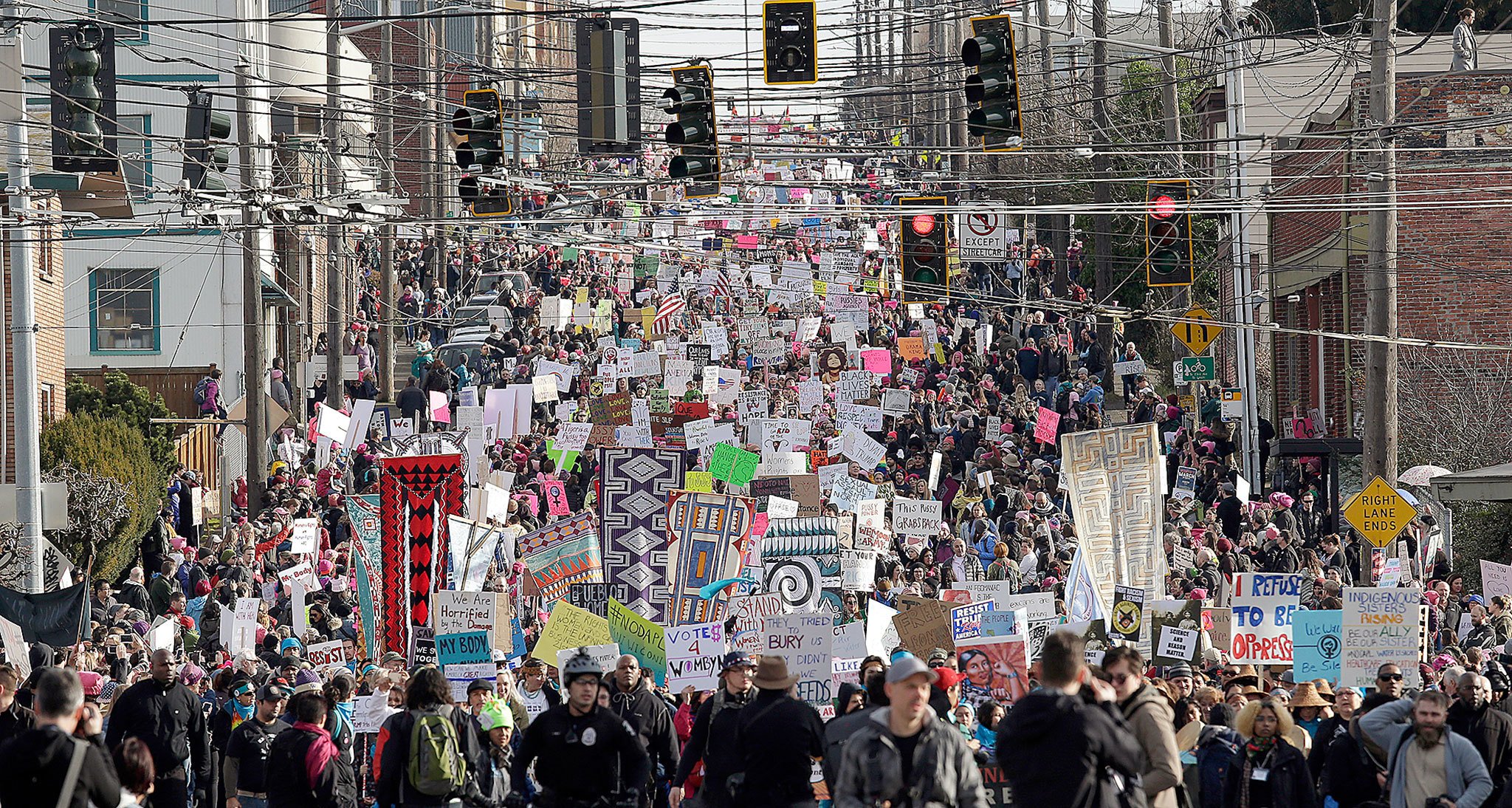 An estimated 150,000 demonstrators fill a street headed toward downtown Seattle during a women’s march Saturday. (AP Photo/Elaine Thompson)
