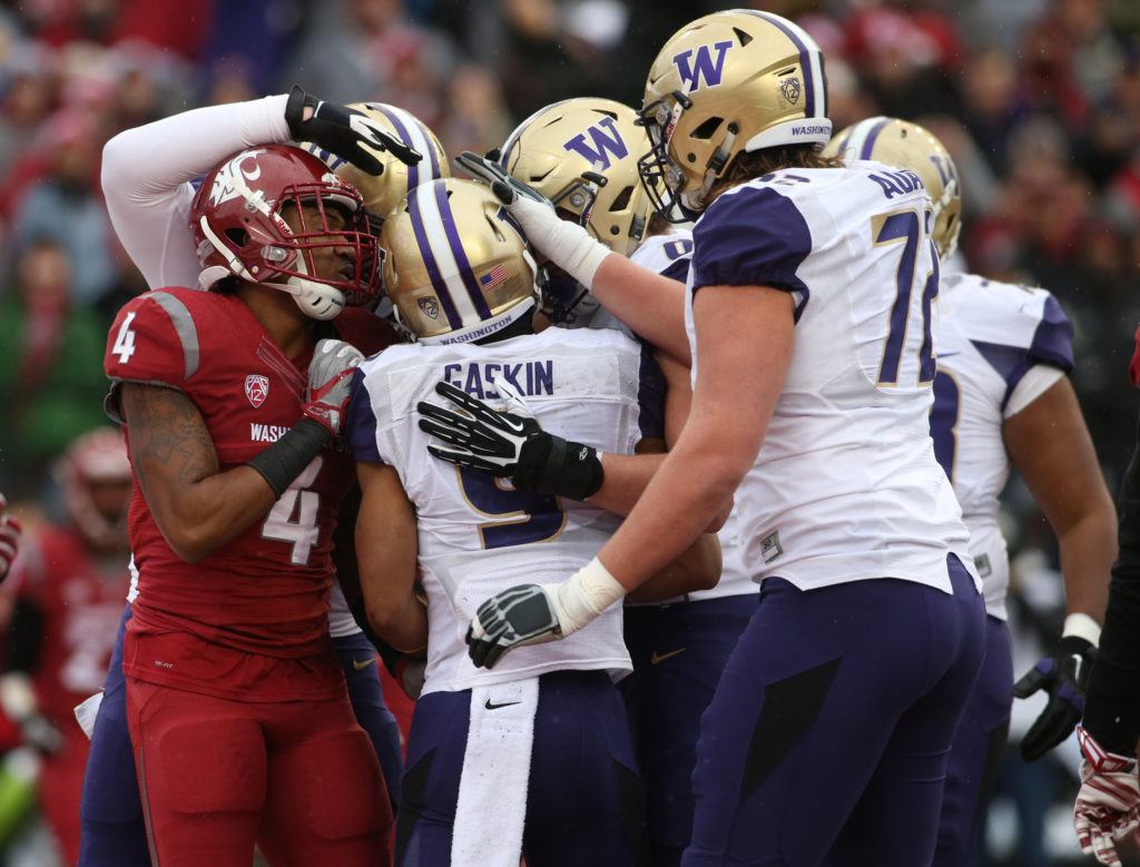 Washington State University’s Charleston White gets caught in the celebration after University of Washington running back Myles Gaskin scores a touchdown in the first quarter of the Apple Cup on Nov. 25, 2016, in Pullman. (Andy Bronson / The Herald)
