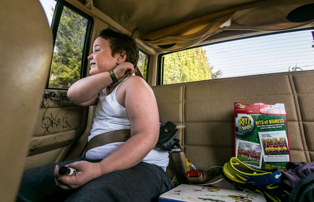 Jessie Pyles rides is his customary seat on the way home from the dentist’s office. The family tries not let Jessie ride in any other vehicles due the damage he causes and his ever-present black marker. (Kevin Clark / The Herald)