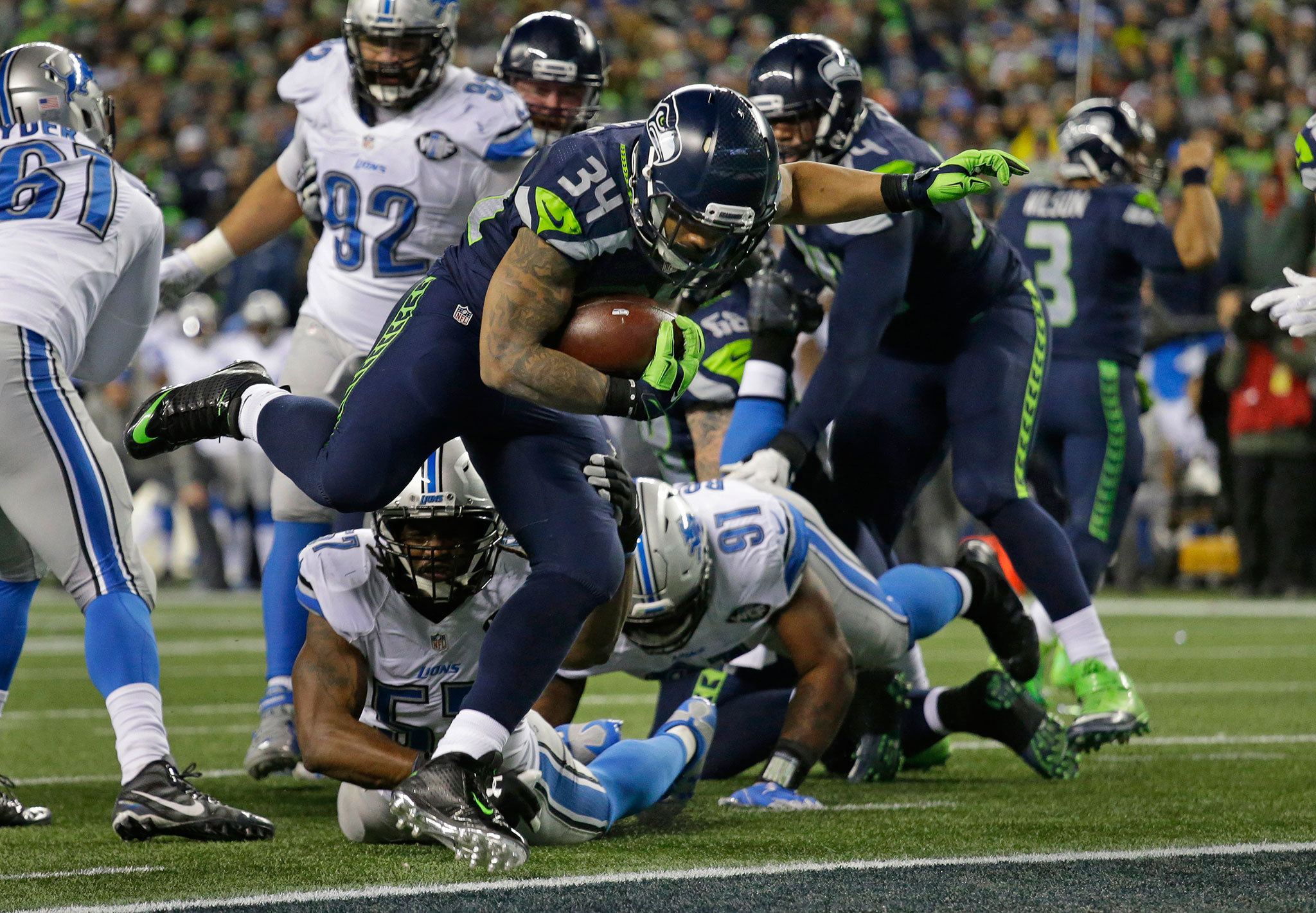Seahawks running back Thomas Rawls (34) rushes for a touchdown against the Lions in the second half of a NFC playoff game on Saturday in Seattle. (AP Photo/Elaine Thompson)