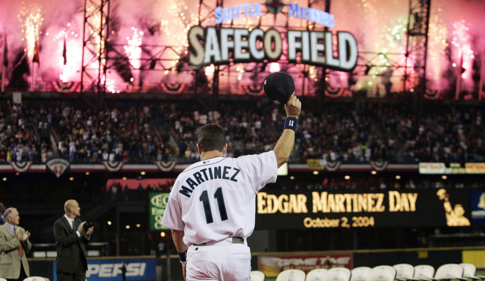 The Mariners’ Edgar Martinez waves his cap as fireworks go off while he is introduced at a post-game ceremony honoring his pending retirement on Oct. 2, 2004, in Seattle. (AP Photo/Elaine Thompson)
