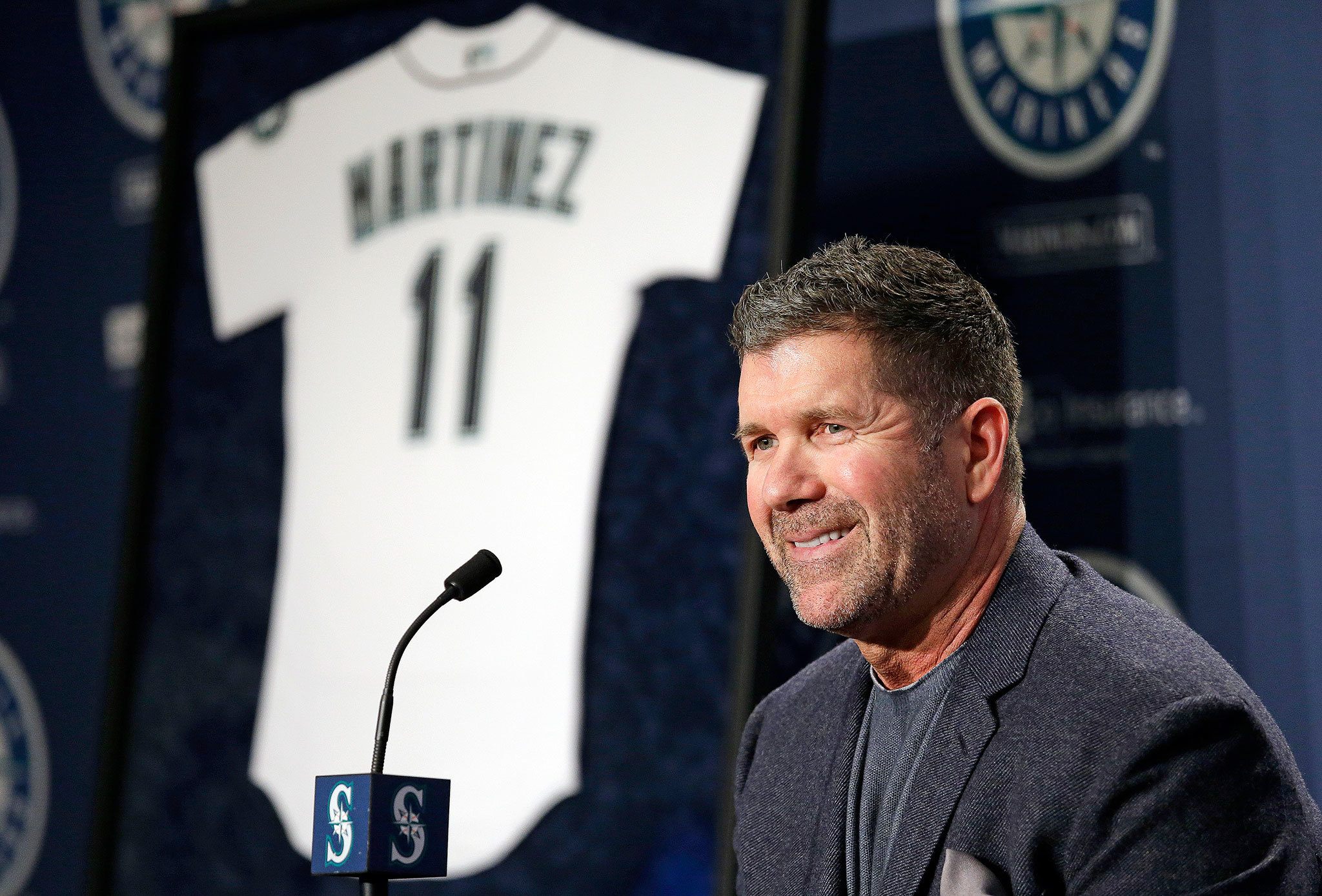 Former Seattle Mariners designated hitter Edgar Martinez smiles as he speaks at a news conference Tuesday announcing the team’s plans to retire his No. 11. (AP Photo/Elaine Thompson)