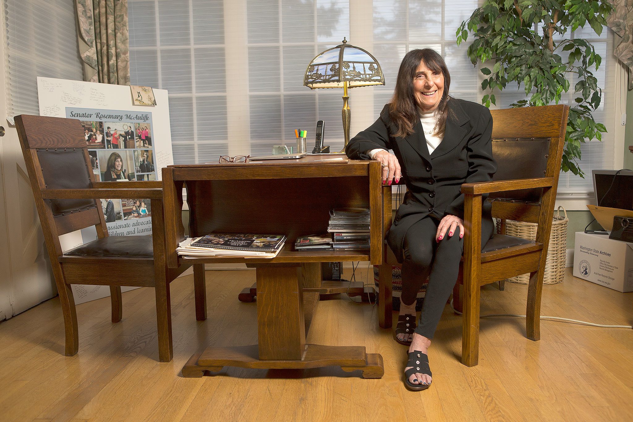 Rosemary McAuliffe sits at her home in Bothell with the chairs and a desk from her days in the state House ofRepresentatives, where she has served since 1993. (Andy Bronson / The Herald)