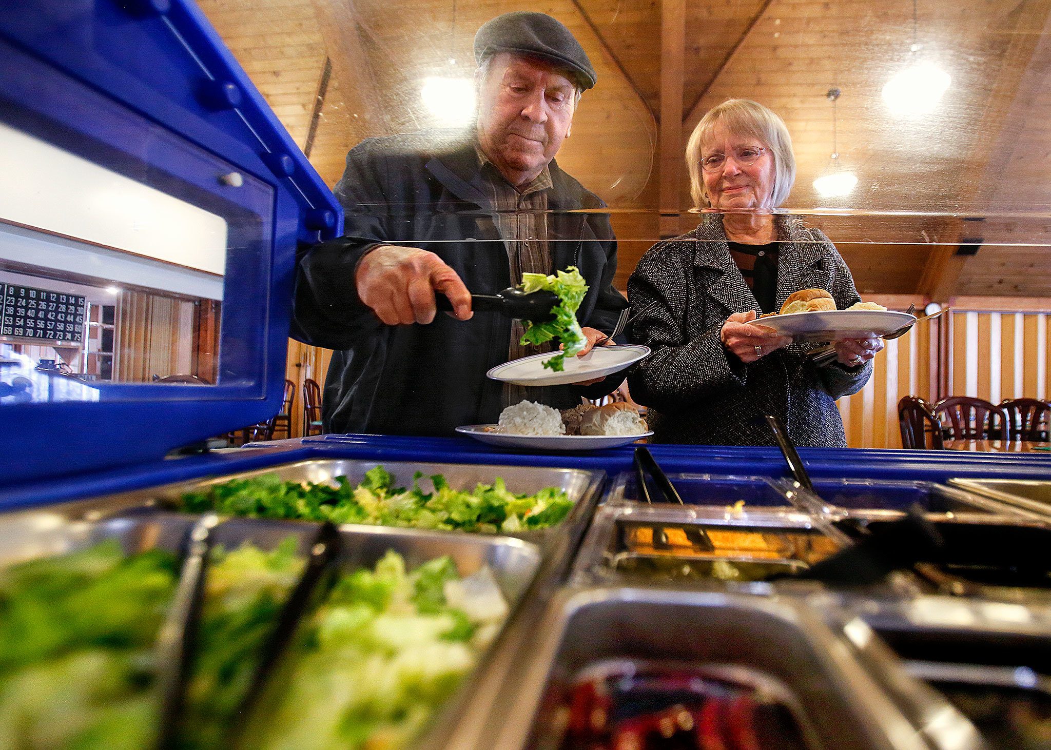 Frank and Nancy Roesler, of Startup, grab a little salad with lunch Jan. 3, two days before their 66th wedding anniversary, at the Sky Valley Senior Center in Sultan. The center, started by a group of seniors with help from Volunteers of America to offer meals, exercise classes and more, has been struggling to keep the lights on, despite a fundraising campaign launched by the VOA. (Dan Bates / The Herald)