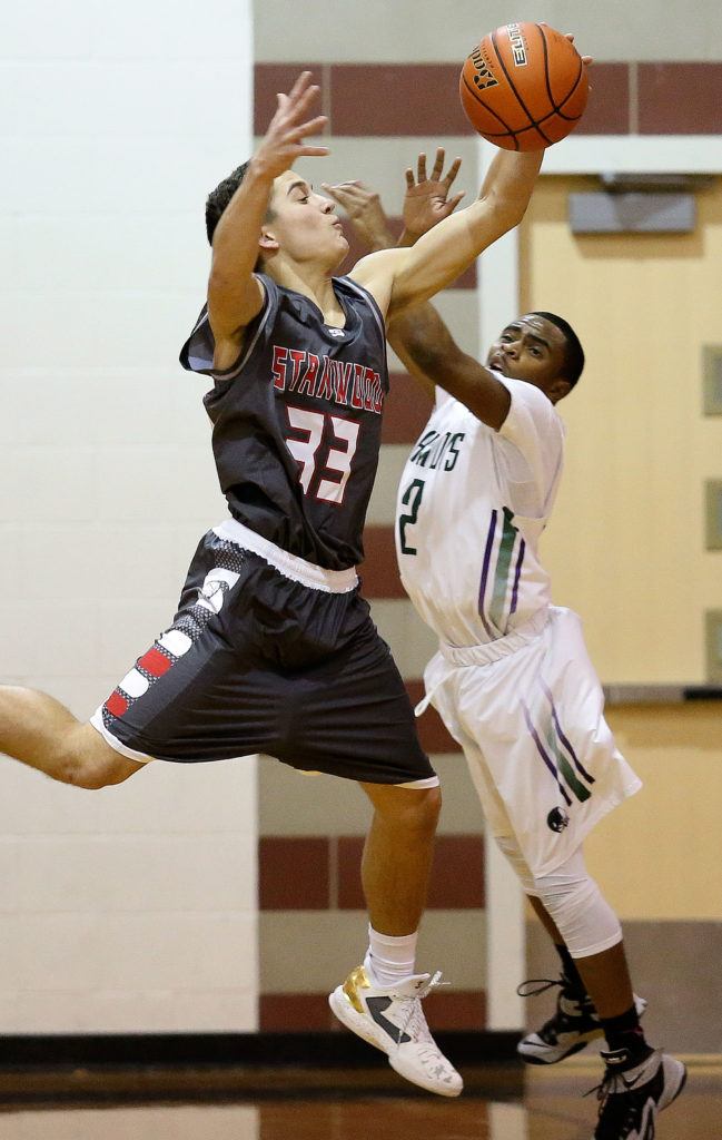 Stanwood’s Nate Kummer (left) steals a pass intended for Edmonds-Woodway’s Jalen Nash (right) during a boys game Tuesday at Edmonds-Woodway High School in Edmonds. Stanwood won 85-66. (Andy Bronson / The Herald)
