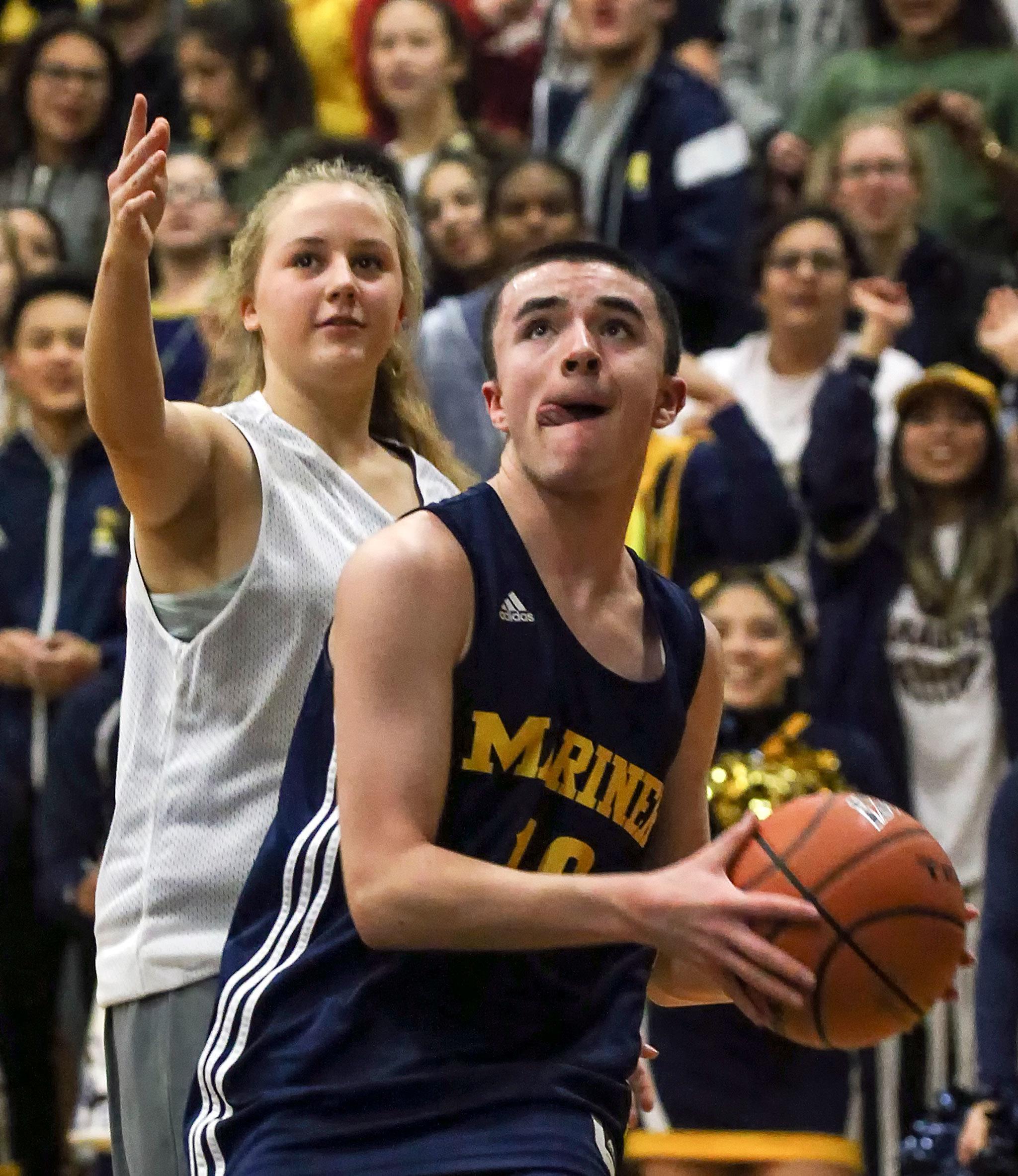Mariner’s Seijin Dupuy drives the baseline with Kamiak’s Olivia Albright trailing during Thursday night’s Varsity Unified game at Kamiak High School. (Kevin Clark / The Herald)