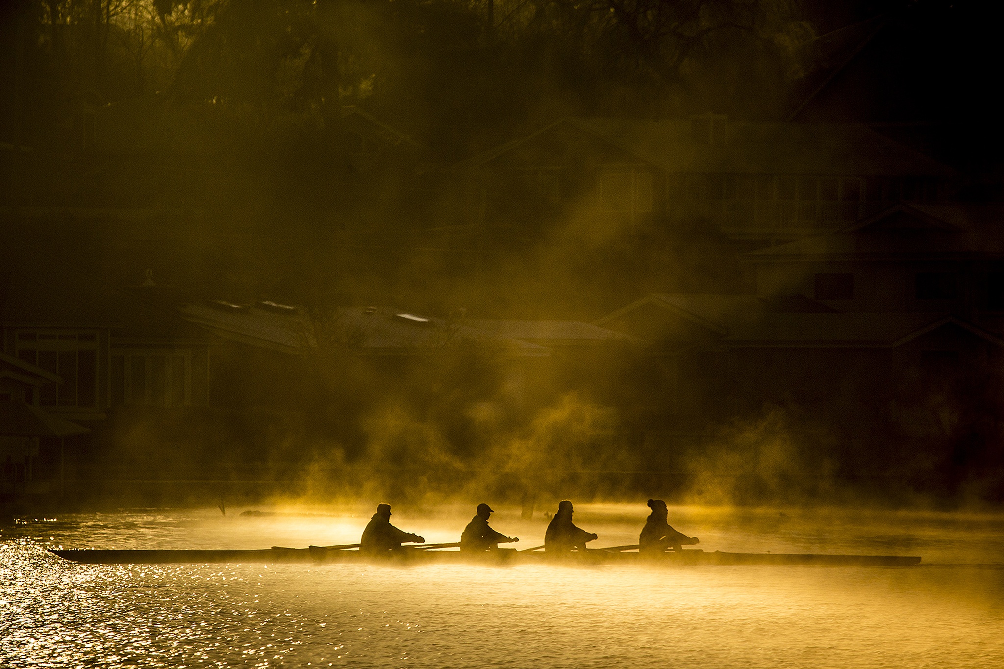 Early morning sunlight glistens off of a misty Lake Stevens on Saturday as members of the Lake Stevens Rowing Club glide across the water during a practice. The club is currently in its 20th year. (Ian Terry / The Herald)