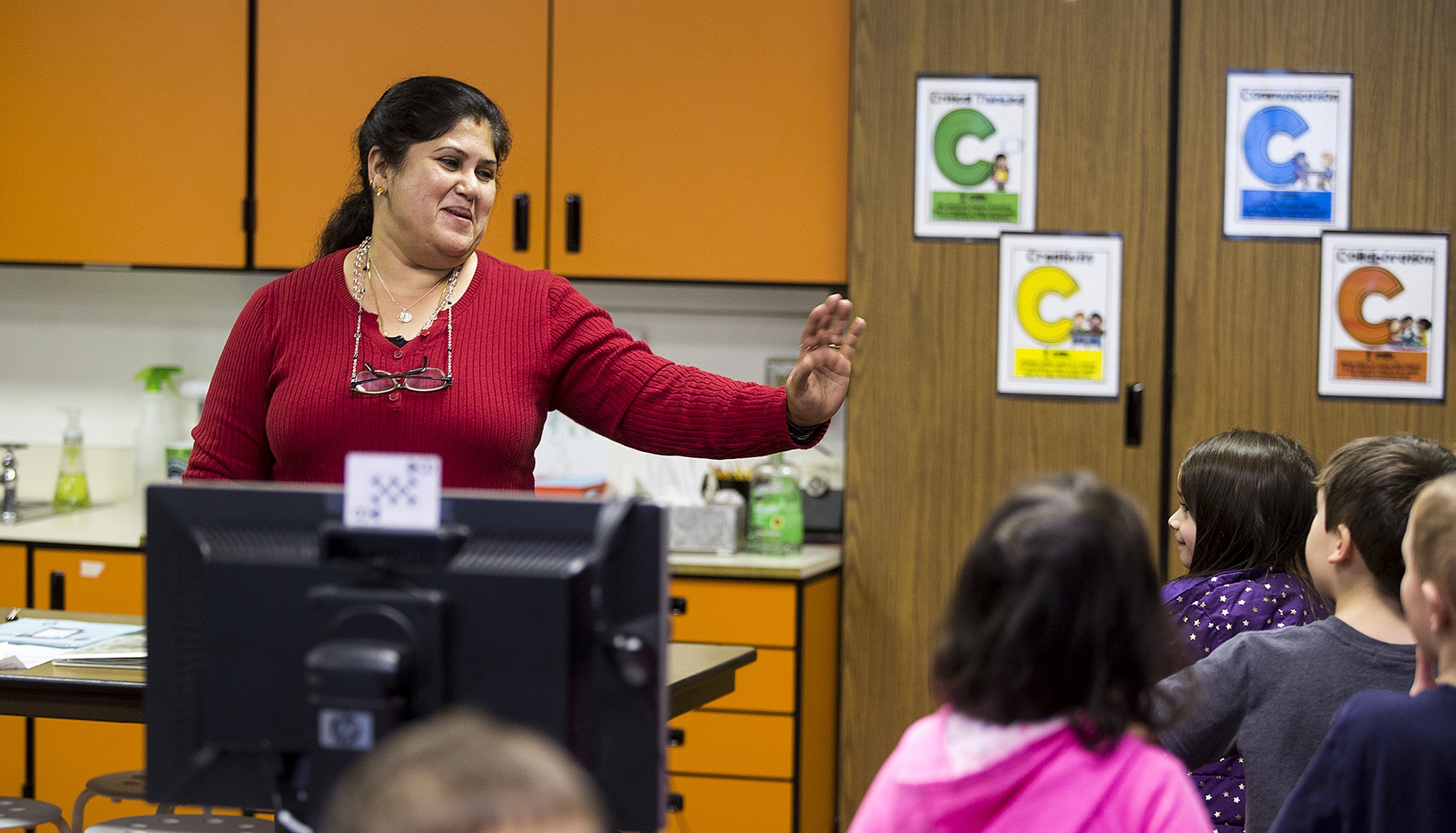 Raj Hariharan, a substitute teacher in the Everett School District, waves goodbye to a kindergarten class she often works with at Woodside Elementary School in Bothell on Thursday. (Ian Terry / The Herald)