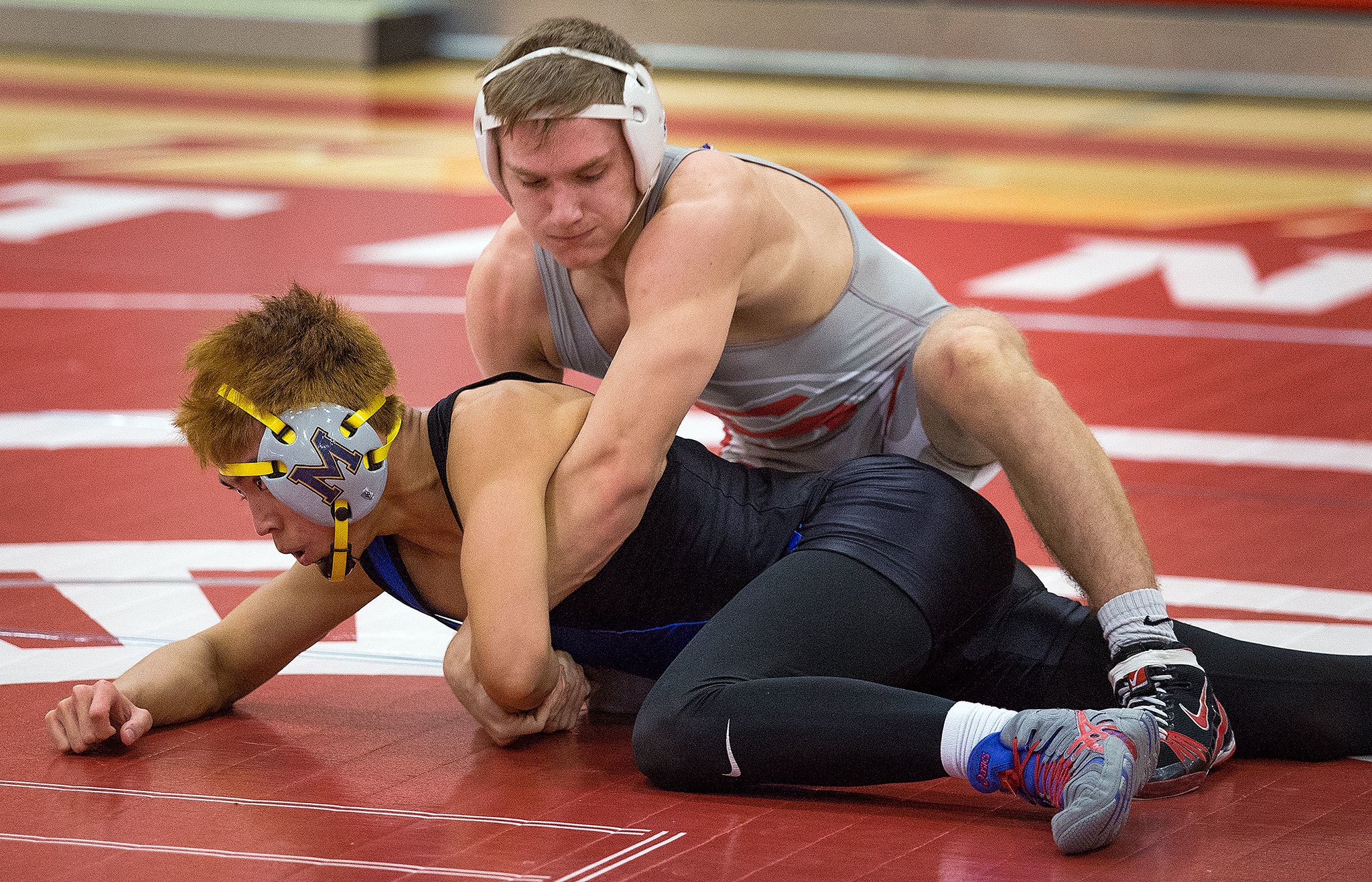 Stanwood’s Mason Phillips (top) wrestles Mariner’s Josh Giron during a match this past Tuesday in Stanwood. Phillips beat Giron by technical fall 18-3. (Andy Bronson / The Herald)