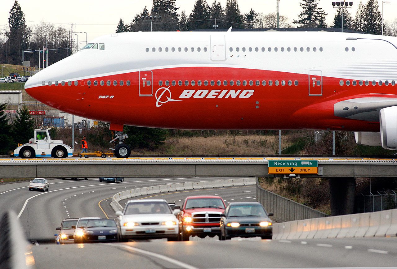 A Boeing 747-8 Intercontinental is moved across Highway 526 from the Everett assembly plant to the fuel dock in 2011. (Michael O’Leary/The Herald)