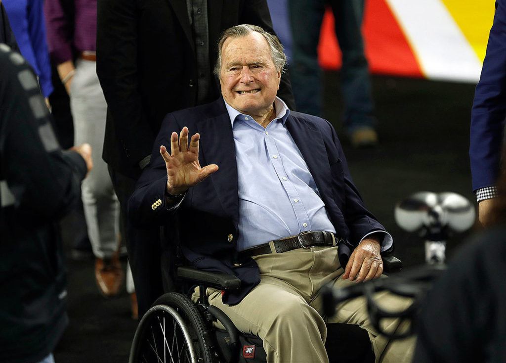 In this April 2, 2016 photo, former President George H. W. Bush waves as he arrives at NRG Stadium before the NCAA Final Four tournament college basketball semifinal game between Villanova and Oklahoma in Houston. (AP Photo/David J. Phillip, File)
