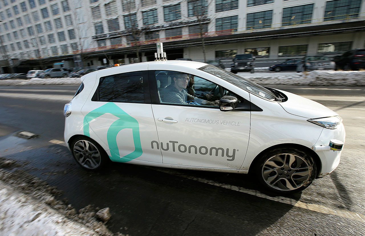 An autonomous vehicle is driven by an engineer in an industrial park in Boston on Jan. 10. (AP Photo/Steven Senne)