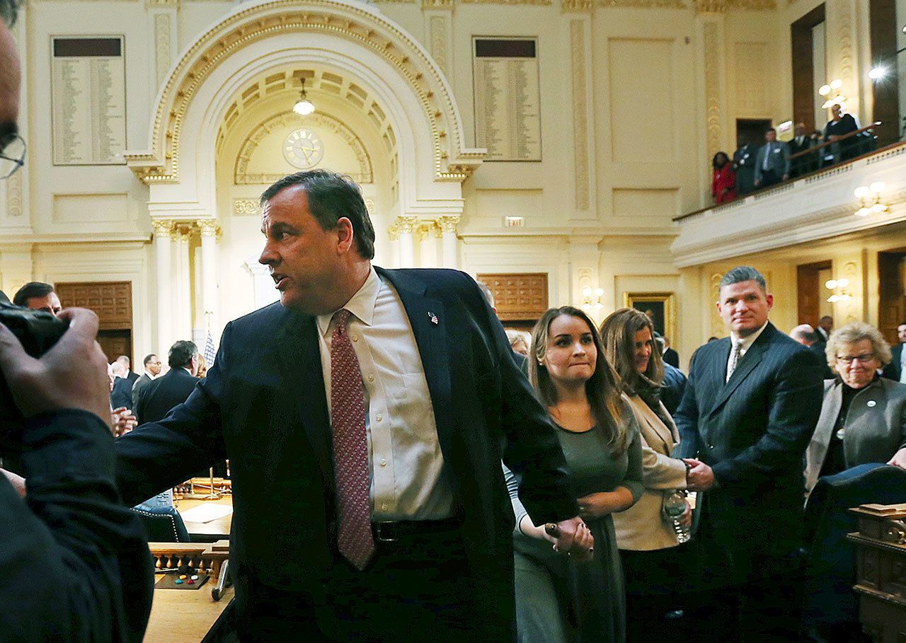 New Jersey Gov. Chris Christie holds hands with daughter Sarah Christie, as wife Mary Pat Christie follows, while leaving the Assembly chamber of the Statehouse after he delivered his State Of The State address Tuesday, Jan. 10, in Trenton, New Jersey. (AP Photo/Mel Evans)